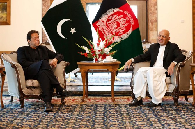 Pakistan's Prime Minister Imran Khan (L) and Afghan President Ashraf Ghani attend their meeting at the Presidential Palace in Kabul on November 19, 2020. (AFP)