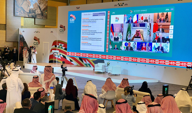 Media watches Saudi King Salman bin Abdulaziz's virtual speech live at the media centre during an opening session of the 15th annual G20 Leaders' Summit in Riyadh on Nov. 21, 2020. (REUTERS)