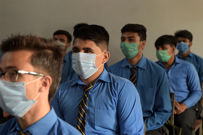 Students wearing facemasks attend a class at a school in Peshawar on September 15, 2020. (AFP)