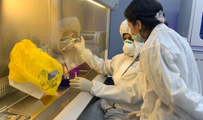 Scientists examine samples at the Public Health Reference Laboratory in Lahore, April 23, 2020. (AN Photo/Natasha Zia)