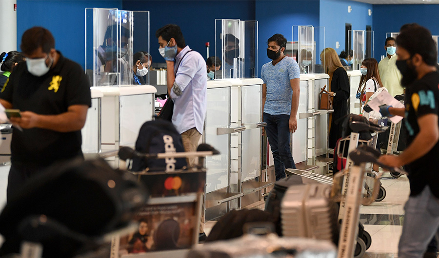 Pakistani nationals check in at the Dubai International Airport before leaving the Gulf Emirate on a flight back to her country, on May 7, 2020. (AFP)