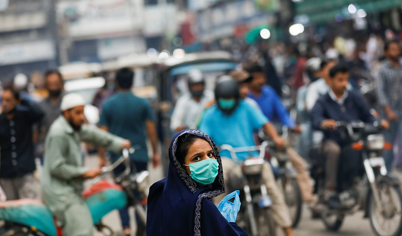 A woman wears a protective face mask as she walks along a road, as the outbreak of the coronavirus disease (COVID-19) continues in Karachi, Pakistan, July 7, 2020. (REUTERS/File)