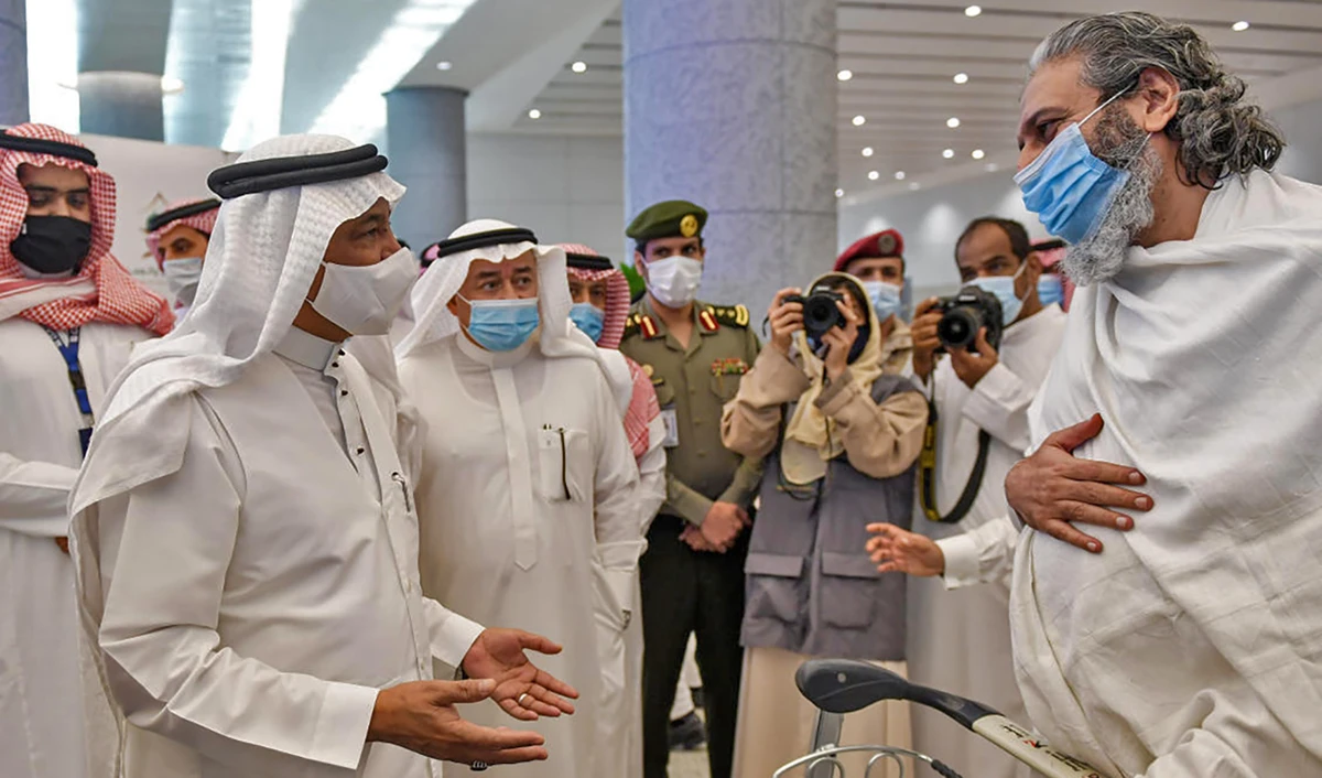 Mohammed Saleh Benten (2nd-L), Minister of Hajj and Umrah, welcomes Pakistani travellers arriving in Saudi Arabia to perform Umrah at King Abdulaziz International Airport in Jeddah on Sunday. (AFP)