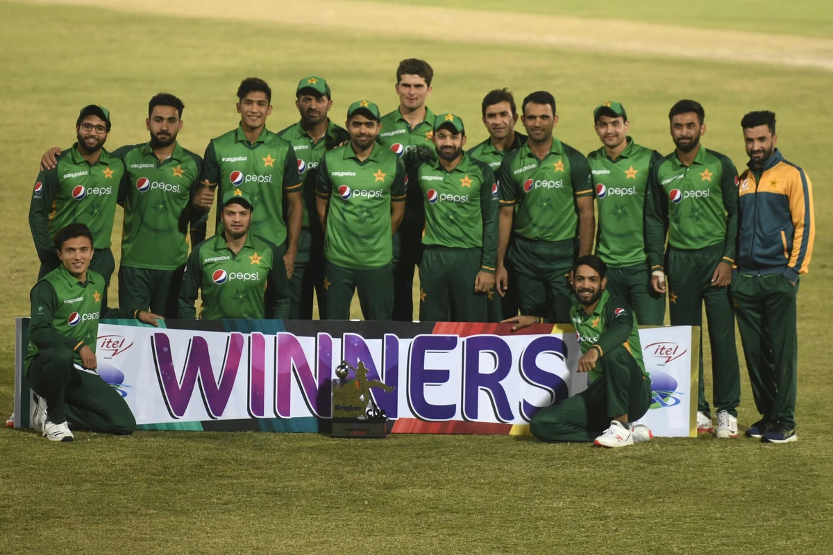 Pakistan's players pose for a picture with the trophy after winning the one-day international (ODI) cricket series against Zimbabwe at the Rawalpindi Cricket Stadium in Rawalpindi on November 3, 2020. (AFP)