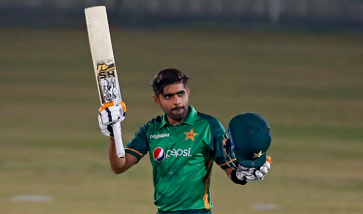 Pakistani batsman Babar Azam raises his bat and helmet to celebrate his century during the 3rd one-day international cricket match against Zimbabwe at the Pindi Cricket Stadium, in Rawalpindi on Nov. 3, 2020. (AP)