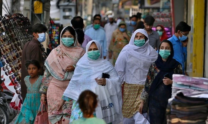 In this file photo a family wearing masks to help curb the spread of the coronavirus visits a market in Rawalpindi, Pakistan, June 2, 2020. (AP)