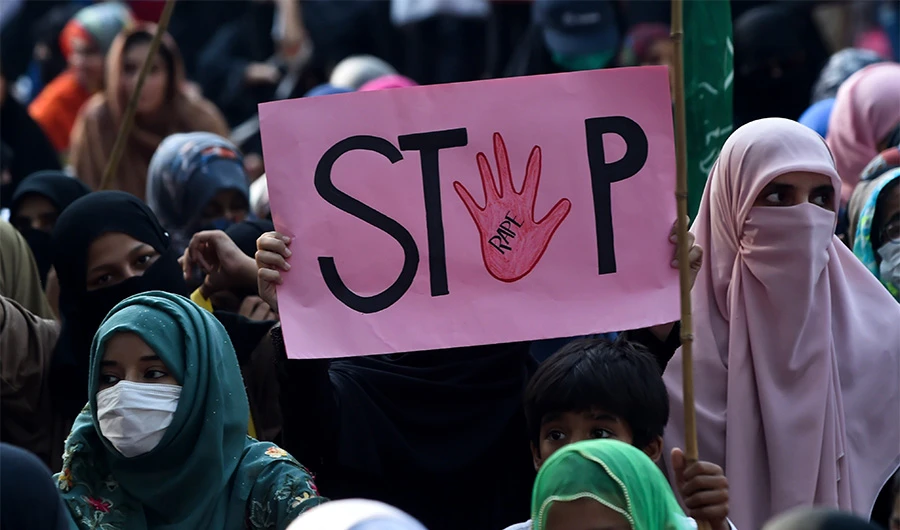 A supporter of Pakistani Islamic political party Jamaat-e-Islami (JI) holds a placard reading "Stop" during a protest against an alleged gang rape of a woman, in Lahore on September 17, 2020. (AFP)