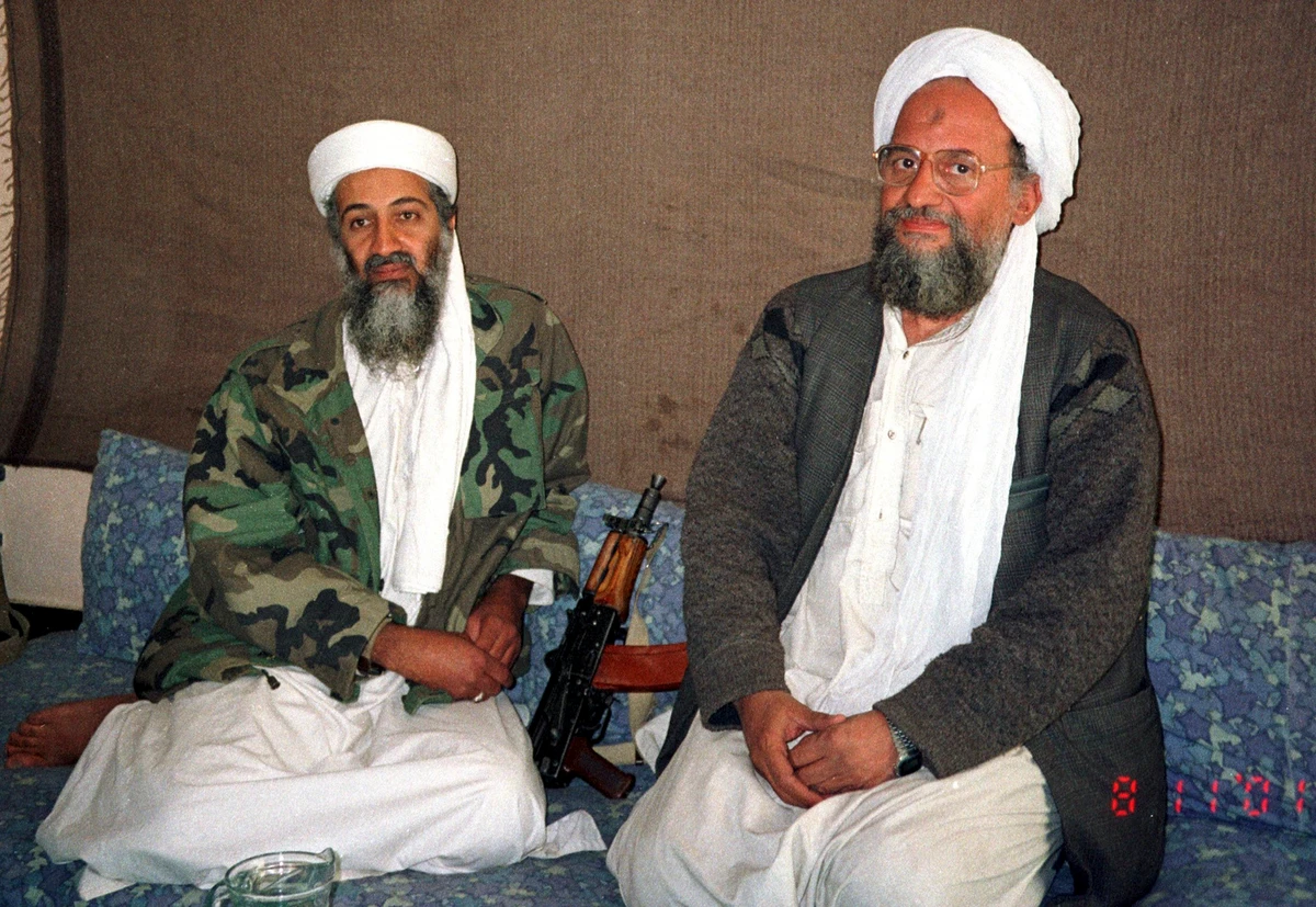 Osama bin Laden, left, sits with his adviser and later successor Ayman Al-Zawahri during an interview with Dawn newspaper November 10, 2001. (AFP/File)