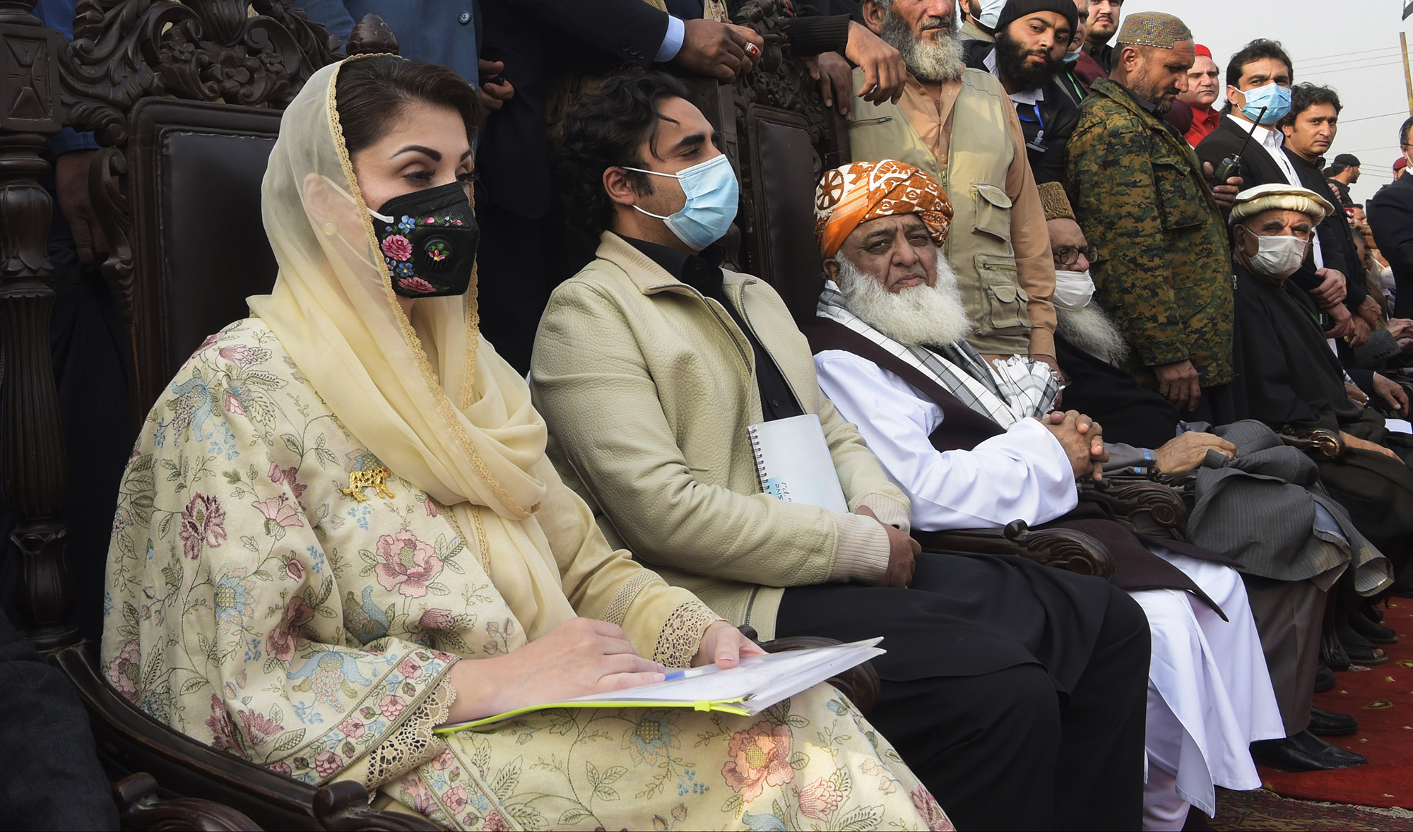 Maryam Nawaz, left, Bilawal Bhutto Zardari, second left, and President of the Jamiat Ulema-e-Islam Maulana Fazlur Rehman, third left, sit on the stage during a political rally in Peshawar on Nov. 22, 2020. (AFP/File)