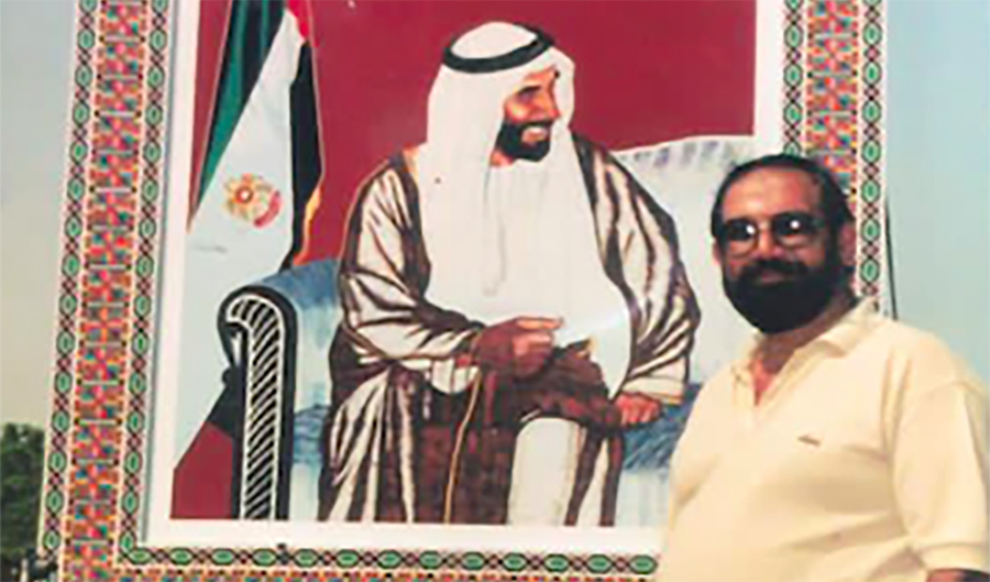 An undated photo of Liaquat Ali Khan, a Pakistani artist, seen posing in front of a portrait he made of UAE's founding father and then ruler, Sheikh Zayed bin Sultan Al Nahyan (Photo courtesy Liaquat Ali Khan)