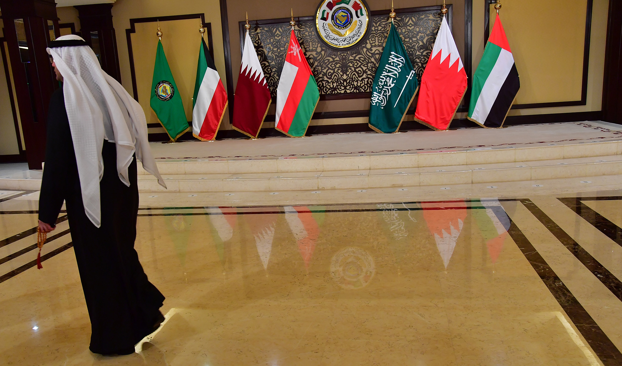 A man walks past the flags of the countries attending the Gulf Cooperation Council (GCC) summit at Bayan palace in Kuwait City on Dec. 5, 2017. (AFP/File)