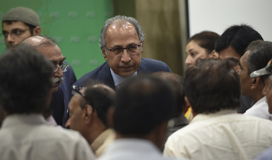 Dr. Abdul Hafeez Shaikh listens to journalists after a media briefing in Islamabad on October 12, 2019. He was sworn in as a federal minister at a ceremony at the President House on Friday, December 11, 2020. (AFP Photo /File)