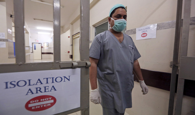 In this file photo, a Pakistani doctor walks out of an isolation ward set up as a preventative measure following the deadly Coronavirus outbreak, at the Jinnah Postgraduate Medical Center in Karachi on Feb. 3, 2020. (AP)