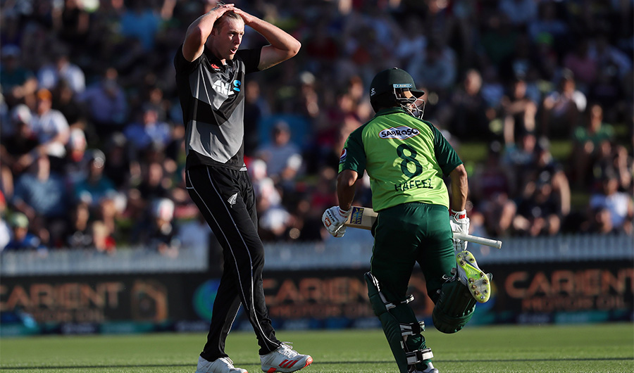 New Zealand’s paceman Kyle Jamieson (L) reacts as Pakistan's Mohammad Rizwan runs between the wickets during the second T20 international cricket match between New Zealand and Pakistan at Seddon Park in Hamilton on December 20, 2020 (AFP)