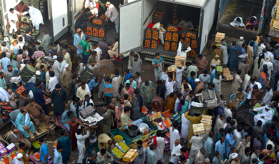 Traders and buyers gather at a fruit market in Lahore on September 27, 2020. (AFP)