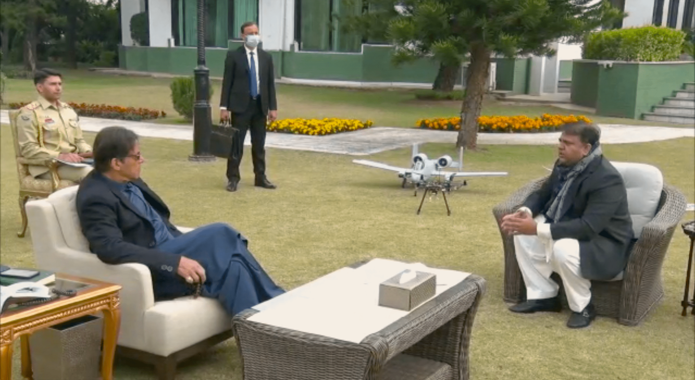 Science and technology minister Fawad Chaudhry briefs PM Khan on the use of drone technology in various fields on December 22, 2020. A drone is seen in the backdrop. (Photo Courtesy: PM Office)