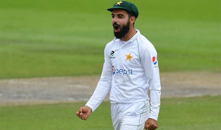 Pakistan's Shadab Khan celebrates after taking a catch to dismiss England's Ollie Pope for 7 during play on the fourth day of the first Test cricket match between England and Pakistan at Old Trafford in Manchester, north-west England on August 8, 2020. (AFP)