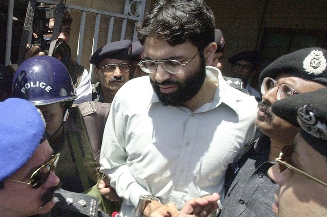 Pakistani police surround handcuffed Ahmed Omar Saeed Sheikh as he comes out of a court Karachi in this file taken on March 29, 2002. (AFP)
