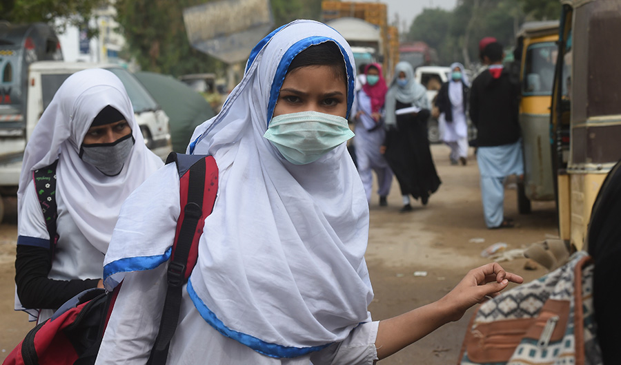 Students wearing facemasks arrive to attend school amid the Covid-19 coronavirus pandemic in Karachi on November 25, 2020. (AFP)