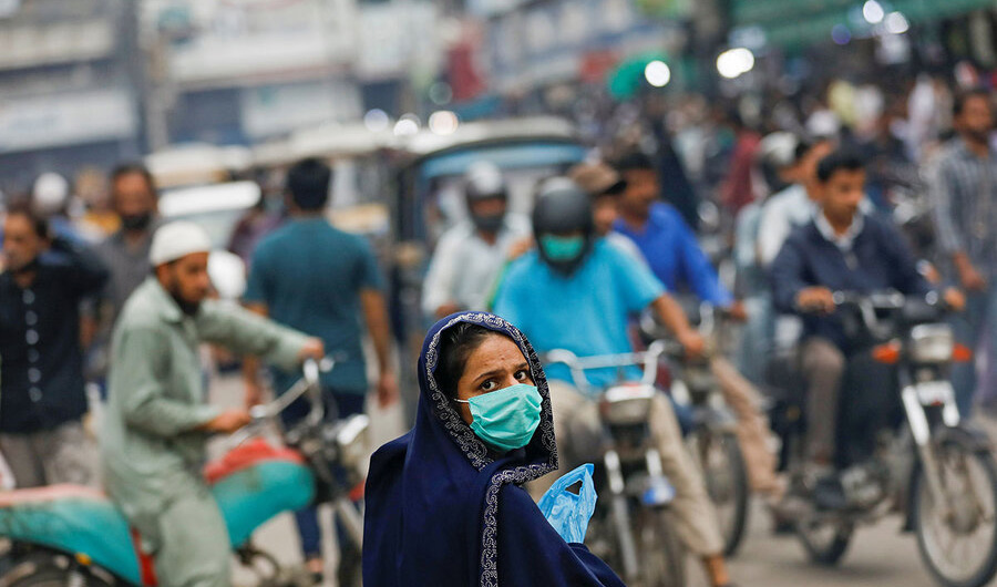 A woman wears a protective face mask as she walks along a road in Karachi, Pakistan July 7, 2020. (AFP/File)