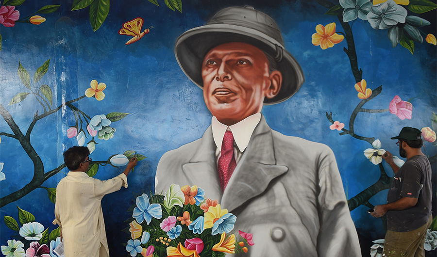 Pakistani artists give final touches to a painting with the image of Pakistan's founder Mohammad Ali Jinnah in Karachi on August 12, 2016. (AFP/File)