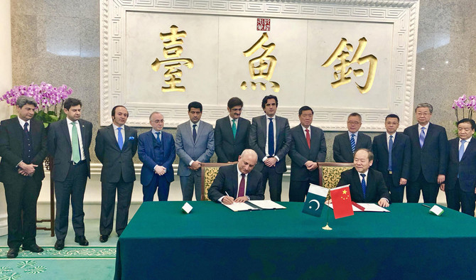 FILE - Haroon Sharif, Minister of State and Chairman of Pakistan Board of Investment, signs an agreement with China for the second phase of the China-Pakistan Economic Corridor (CPEC) project. The deal focuses on investments in industrial ventures of the project. (Photo courtesy: Haroon Sharif/Twitter)