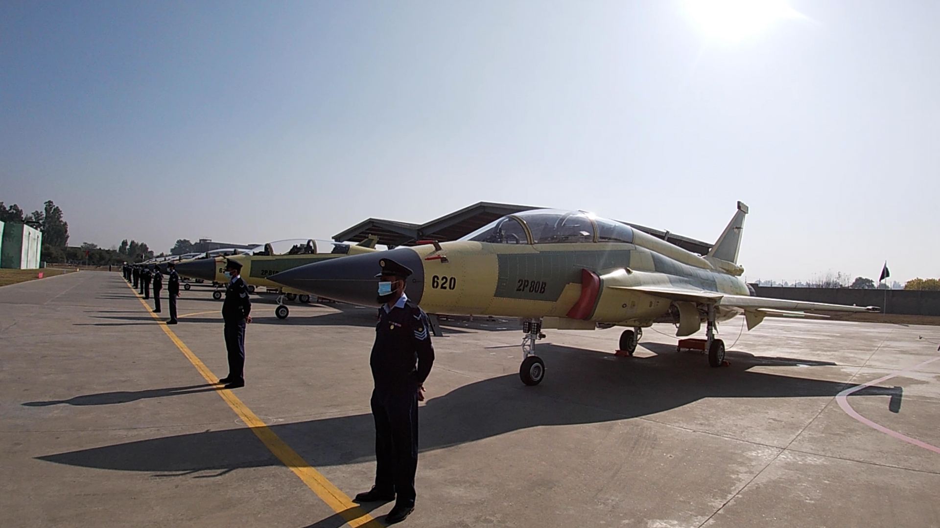 Pakistan servicemen stand in front of 14 dual-seat multirole JF-17 fighter jets freshly inducted into the country’s air force fleet on December 30, 2020 in Kamra. (AN Photo)