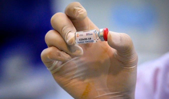 A laboratory technician holds a dose of a COVID-19 vaccine at the National Primate Research Center of Thailand at Chulalongkorn University in Saraburi on May 23, 2020. (AFP/File)