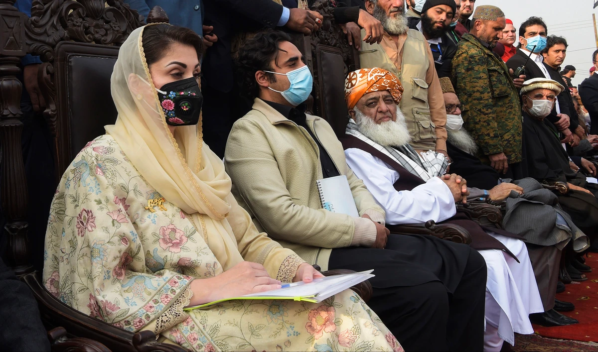 Maryam Nawaz, left, Bilawal Bhutto Zardari, second left, and President of the Jamiat Ulema-e-Islam Maulana Fazlur Rehman, third left, sit on the stage during a political rally in Peshawar on Nov. 22, 2020. (AFP/File)