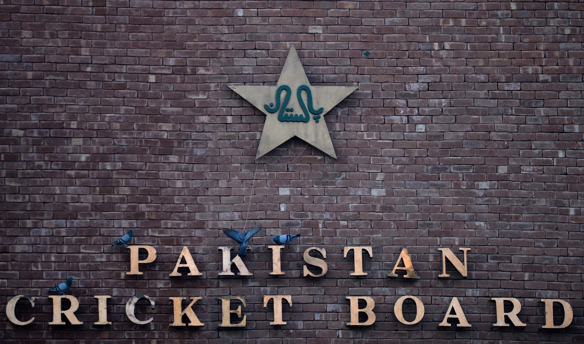 This picture taken on September 7, 2017 shows pigeons resting on a sign for the Pakistan Cricket Board at the Gaddafi Stadium in Lahore. (AFP/File)