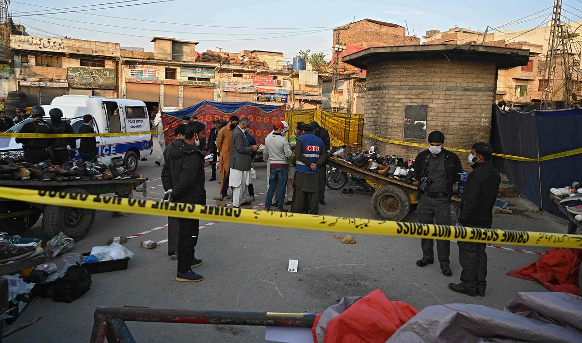 Security officials inspect the site of an explosion at a Ganj Mandi bazar in Rawalpindi on Dec. 13, 2020. (AFP/File)