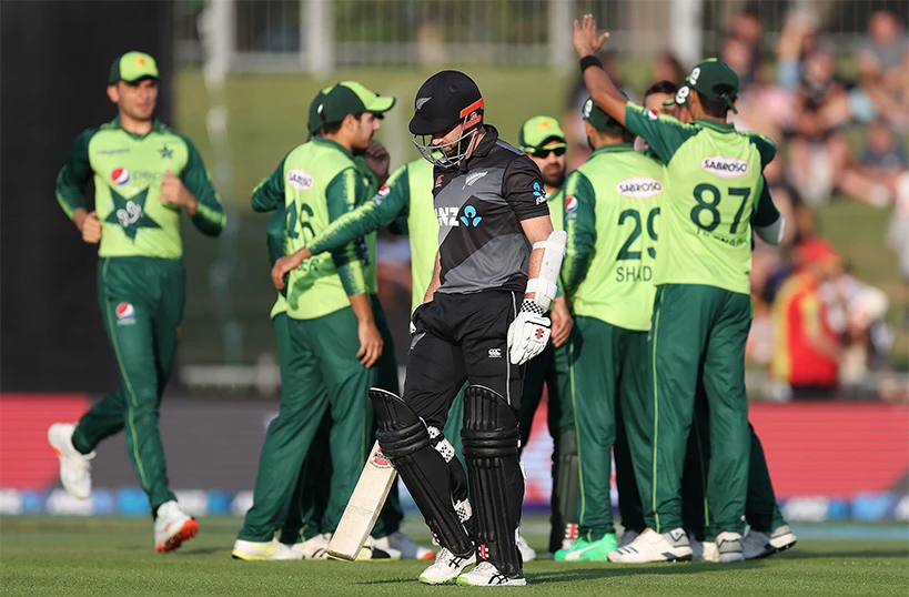 New Zealand's captain Kane Williamson (C) walks back to the pavilion as Pakistan's players celebrate his dismissal during the third T20 cricket match between New Zealand and Pakistan at McLean Park in Napier on December 22, 2020. (AFP)