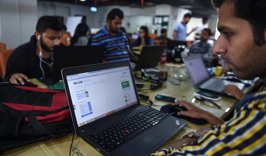 This photograph taken on November 19, 2015 shows Pakistani employees of online marketplace company at work in Karachi. (AFP)