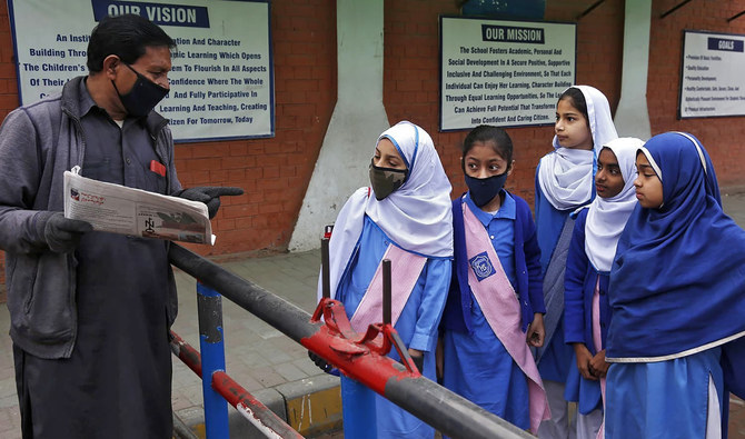 A security guard tells students that their school is closed by authorities to control spread of COVID-19 coronavirus, in Lahore on March 14, 2020. (AP/File)