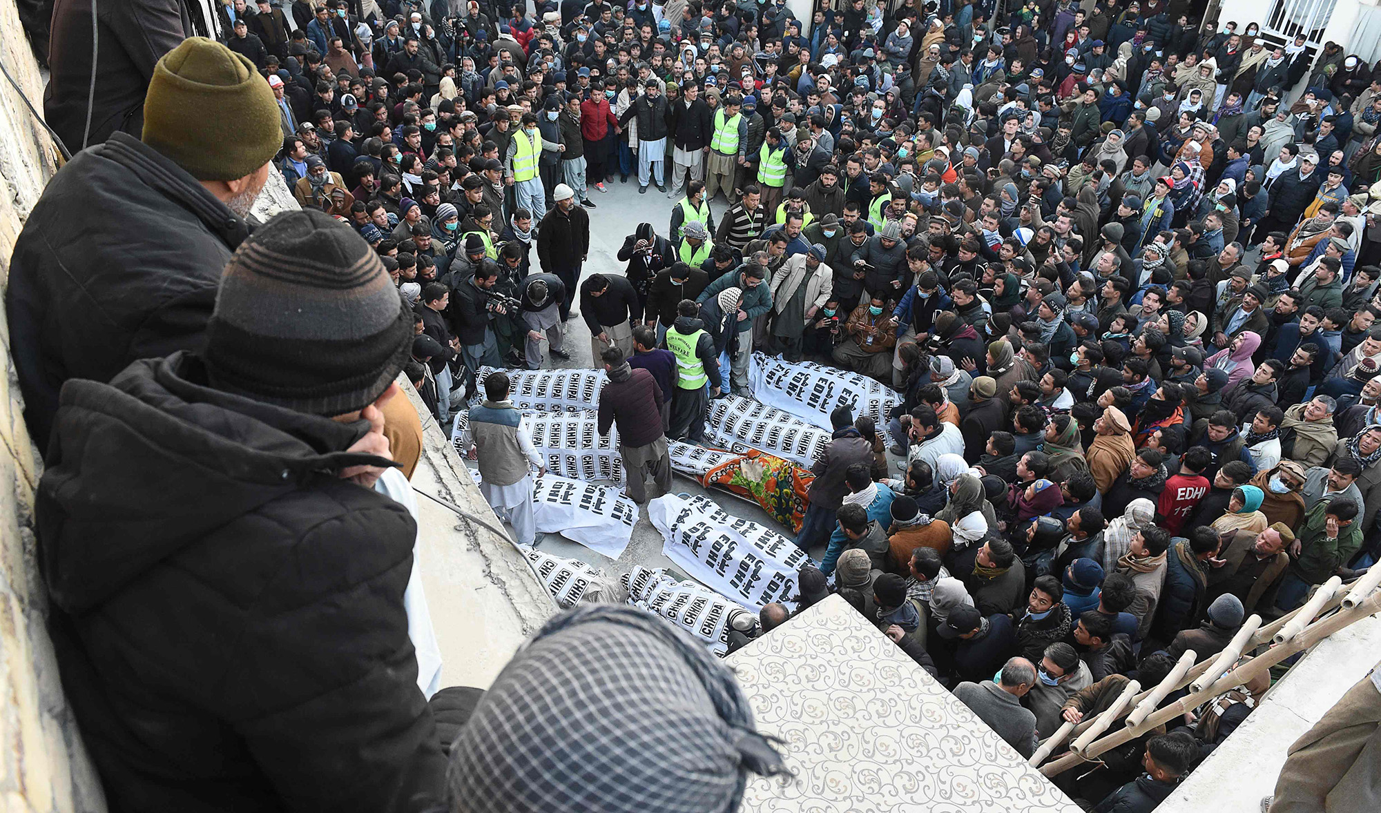 Members of Shiite Hazara community gather around coffins of victims after the killing of 11 workers of their community, in Quetta on Jan. 3, 2021. (AFP)