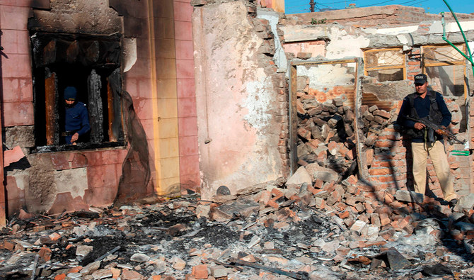 Policemen inspect the burnt Hindu temple a day after a mob attack in a remote village in Karak district, some 160 kms southeast of Peshawar on December 31, 2020. (AFP)