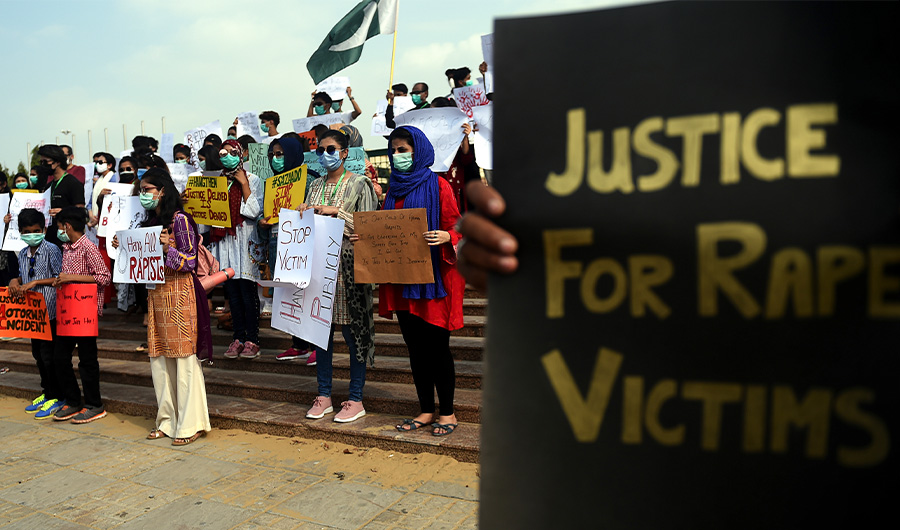In this photo, members of VCare Welfare Trust hold placards during a protest against an alleged gang rape of a woman, in Karachi on September 13, 2020. (AFP)