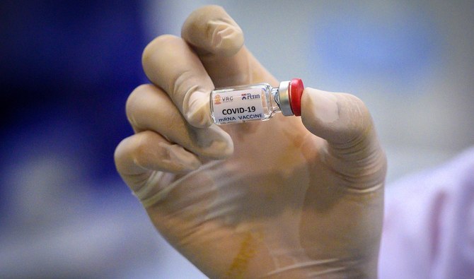 A laboratory technician holds a dose of a COVID-19 vaccine at the National Primate Research Center of Thailand at Chulalongkorn University in Saraburi on May 23, 2020. (AFP/File)