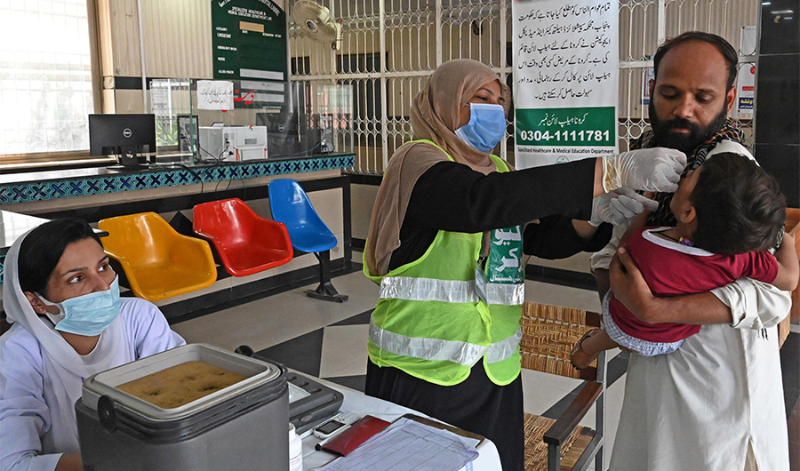 A health worker administers polio vaccine drops to a child during a polio vaccination campaign in Lahore on August 16, 2020. (AFP/File)