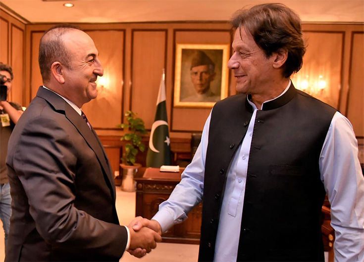 In this file photo photograph released by the Press Information Department (PID) on September 14, 2018, Pakistani Prime Minister Imran Khan (R) shakes hand with visiting Turkish Foreign Affairs Minister Mevlut Cavusoglu (L) before a meeting in Islamabad. (AFP)