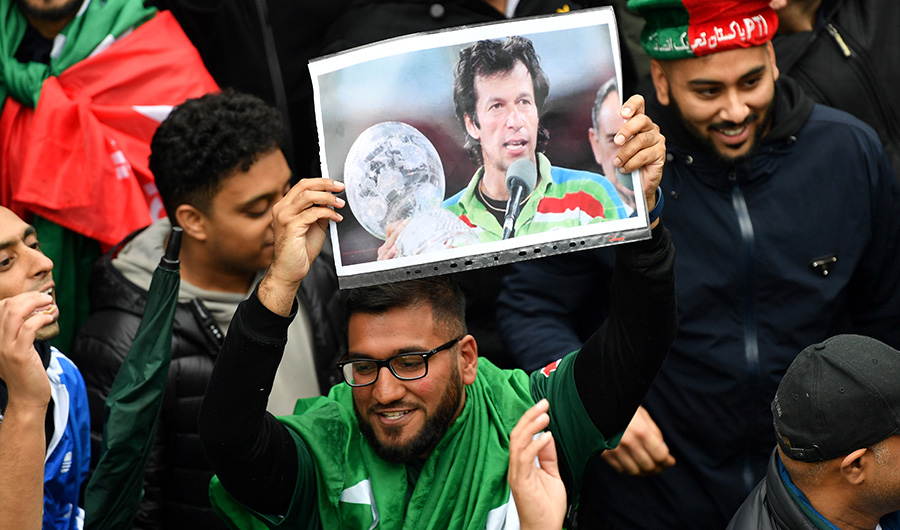 A Pakistani fan holds up a picture of Pakistani Prime Minister Imran Khan as rain delays play ahead the 2019 Cricket World Cup group stage match between Pakistan and Sri Lanka at Bristol County Ground in Bristol, southwest England, on June 7, 2019. (AFP/ File)