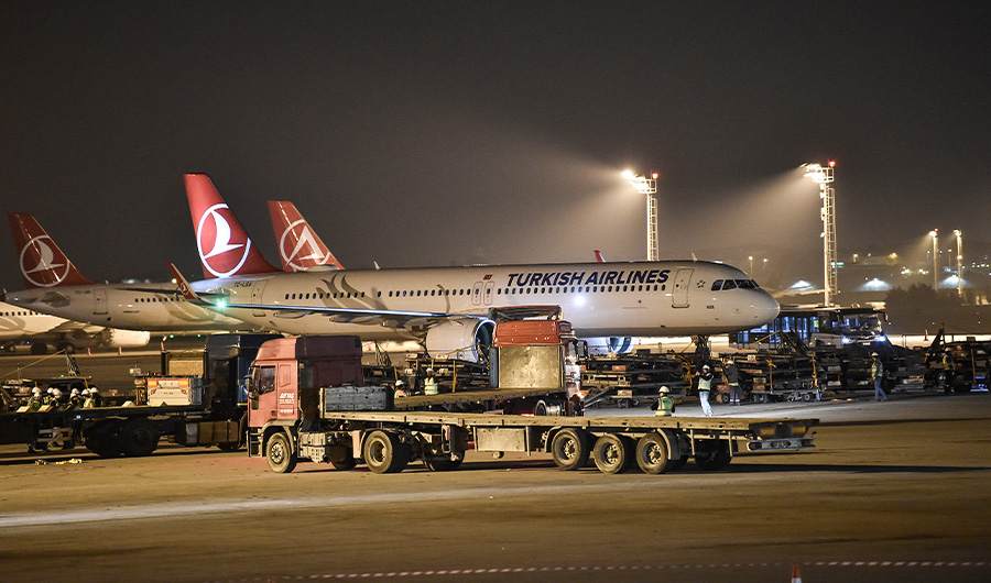 Trucks transport equipments as part of the removal of the Ataturk Airport, next to a Turkish airlines plane, on the last day of flight operations of the Ataturk International airport late on April 5, 2019 in Istanbul. (AFP/File)