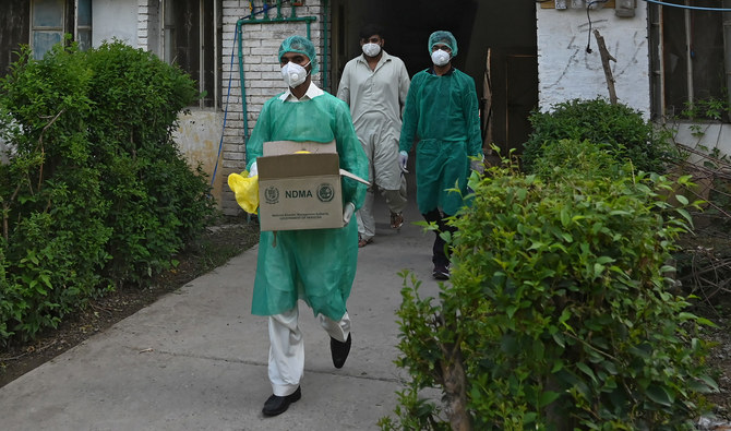 Health officials wearing Personal Protective Equipment (PPE) leave after taking swab samples from residents during a door-to-door screening for the COVID-19 virus at a restricted area sealed by authorities in Islamabad on June 29, 2020. (AFP/File)