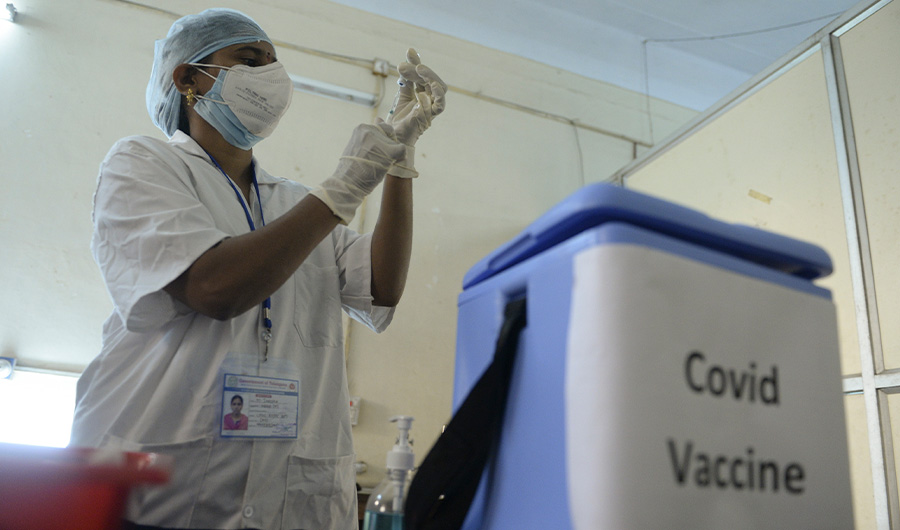 A health worker prepares to inoculate a colleague with a Covid-19 coronavirus vaccine at the Osmania Medical College, in Hyderabad on January 19, 2021. (AFP)