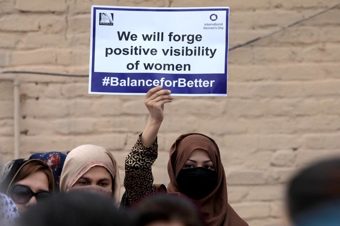 A participant carries a sign during a rally to mark International Women's Day in Peshawar, Pakistan March 8, 2019. (REUTERS)