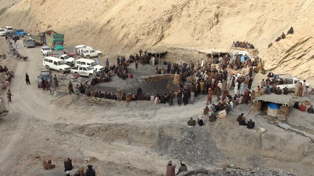 In this file photo, Pakistani miners gather outside a mine in Marwaarh area, 45 kilometers east of Quetta, the capital of oil and gas-rich Balochistan province on May 5, 2018. (AFP)