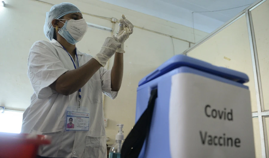A health worker prepares to inoculate a colleague with a Covid-19 coronavirus vaccine at the Osmania Medical College, in Hyderabad on January 19, 2021. (AFP)