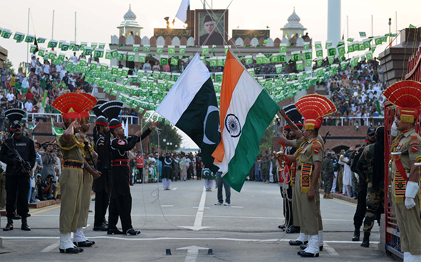 Pakistani Rangers (black uniforms) and Indian Border Security Force personnel (brown uniforms) perform during the daily beating of the retreat ceremony at the India-Pakistan Wagah Border Post, on October 30, 2017. (AFP/File)
