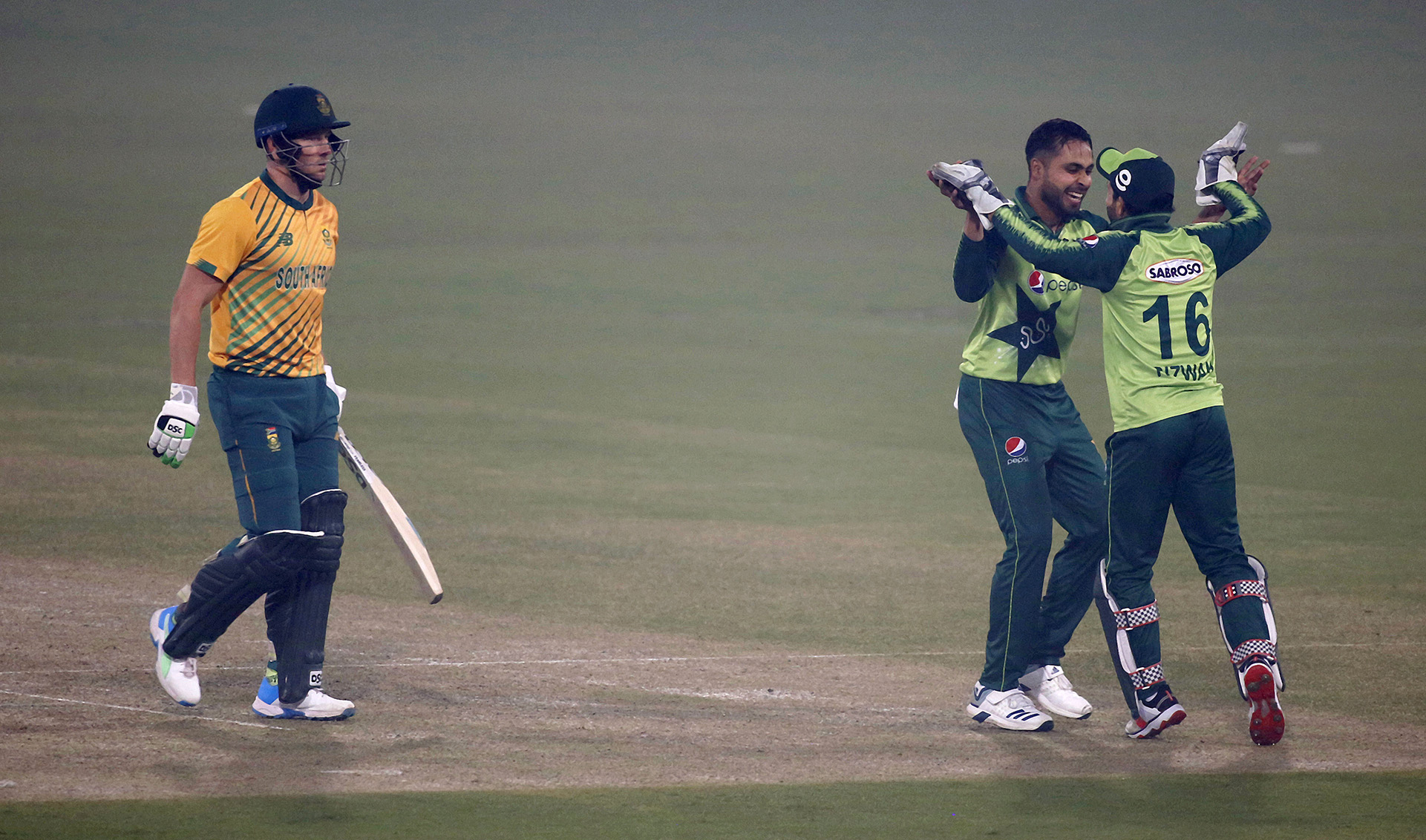 Pakistan's Faheem Ashraf, second right, celebrates with teammate Mohammad Rizwan, right, after taking the wicket of South Africa's David Miller, left, during the 1st Twenty20 cricket match between against South Africa at the Gaddafi Stadium, in Lahore, Pakistan, on February 11, 2021. (AP)