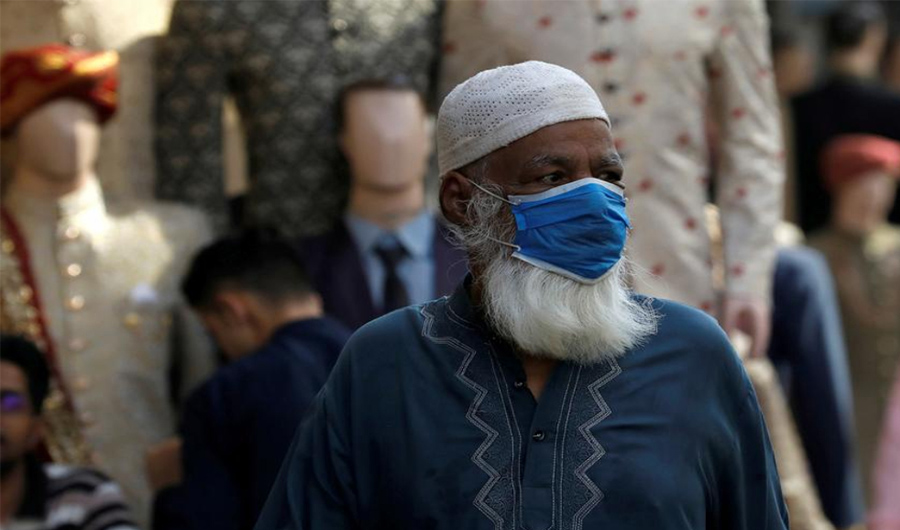 A man wearing a protective face mask, walks past shops at a market, as the outbreak of the coronavirus disease (COVID-19) continues, in Karachi, Pakistan June 1, 2020. (Reuters/File)